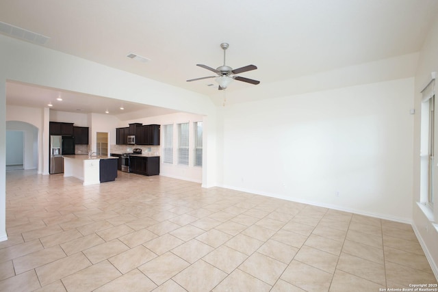 unfurnished living room featuring ceiling fan and light tile patterned floors