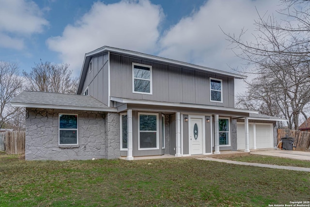 view of front of house featuring a garage and a front lawn