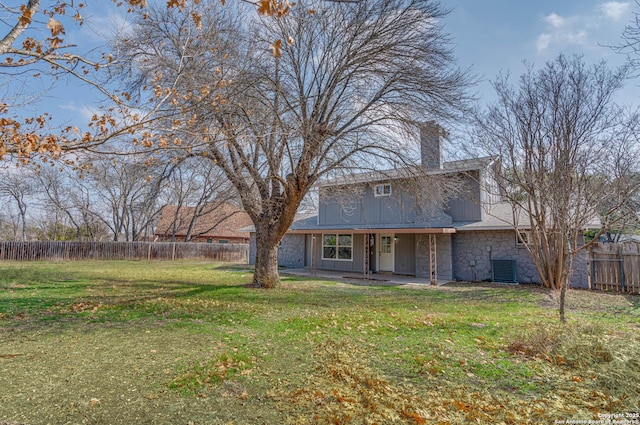 back of property with a lawn