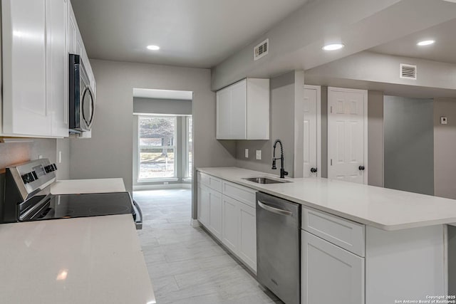 kitchen with white cabinetry, appliances with stainless steel finishes, and sink