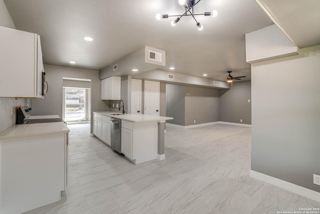 kitchen with stainless steel appliances, ceiling fan with notable chandelier, and white cabinets