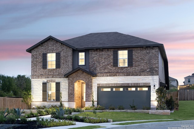 front facade with a yard and a garage