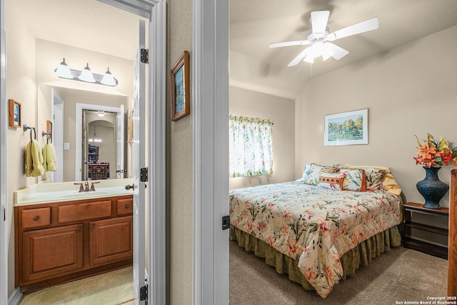 carpeted bedroom featuring ceiling fan, lofted ceiling, and sink