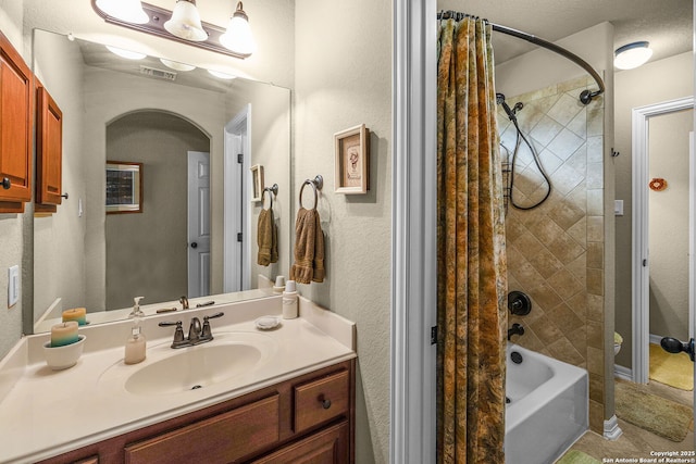 full bathroom with shower / tub combo with curtain, vanity, and toilet