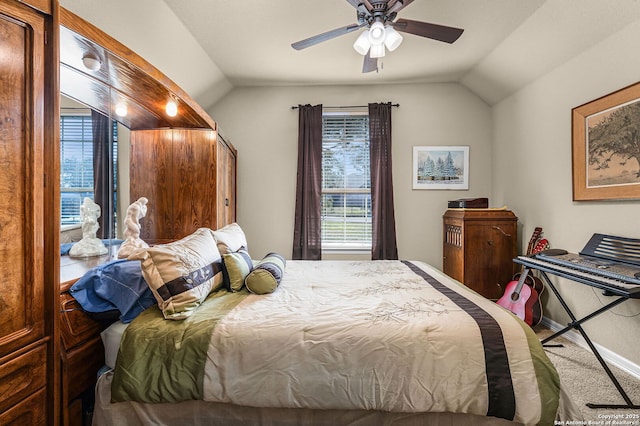 bedroom with lofted ceiling, multiple windows, ceiling fan, and carpet