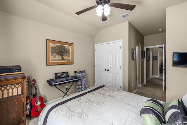 carpeted bedroom featuring vaulted ceiling, ceiling fan, and a closet