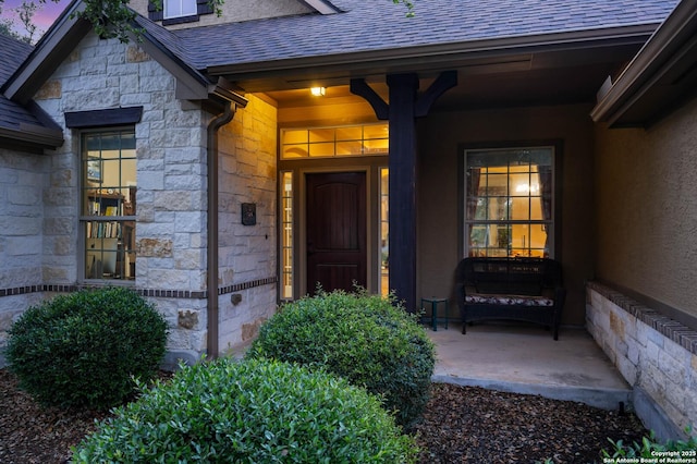 view of exterior entry at dusk