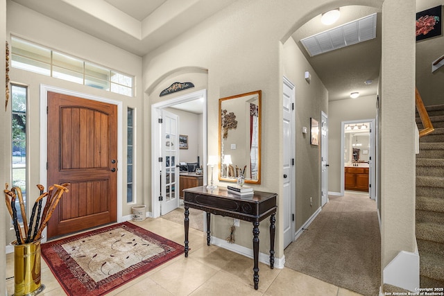 entryway with light tile patterned floors