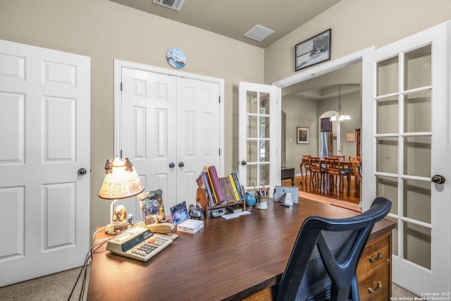 office space with french doors and a notable chandelier