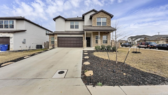 view of front of home with a garage and central air condition unit