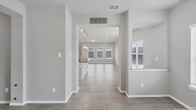 hall featuring light tile patterned floors