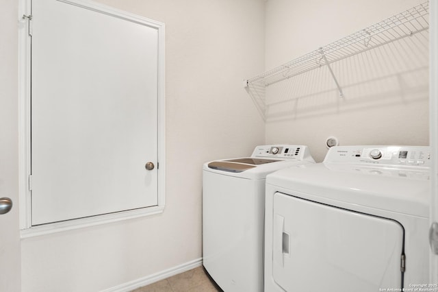 laundry room with light tile patterned floors and washer and dryer