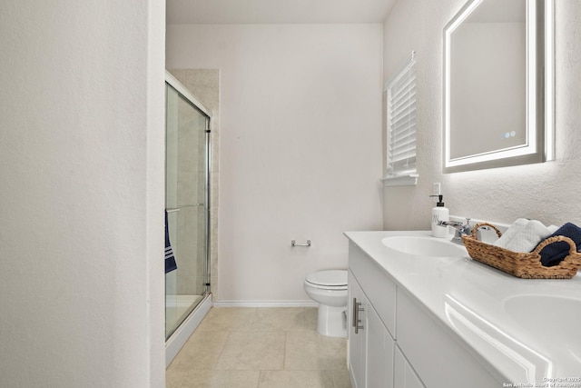 bathroom featuring vanity, a shower with shower door, tile patterned floors, and toilet