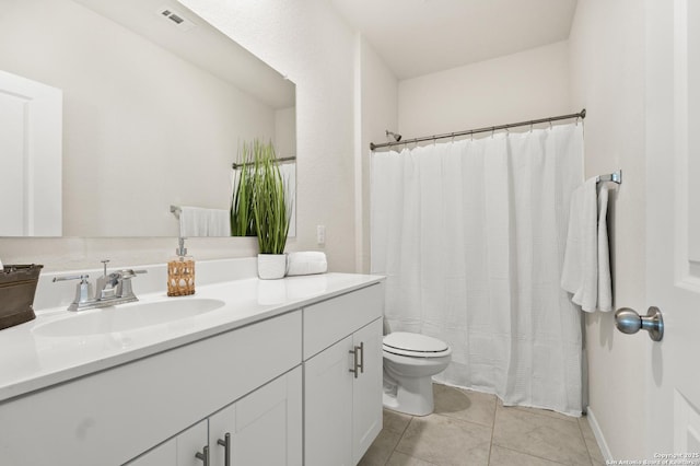 bathroom with vanity, toilet, and tile patterned flooring