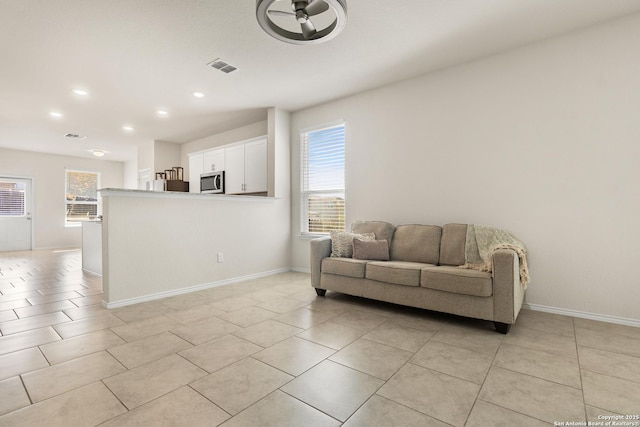 living room featuring plenty of natural light and light tile patterned flooring