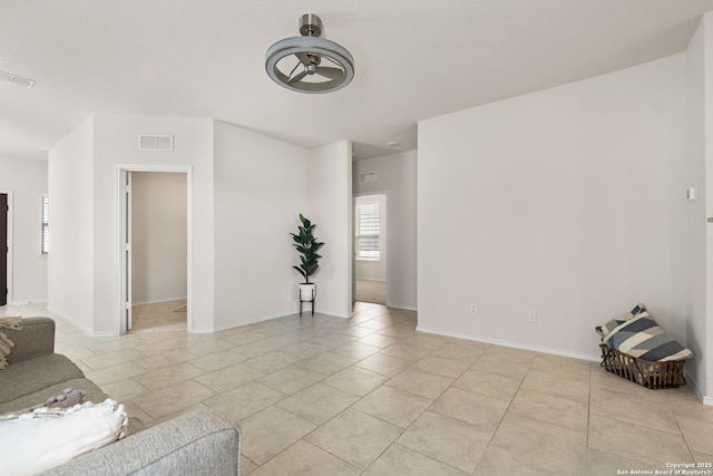 tiled living room featuring ceiling fan