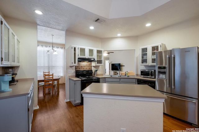 kitchen with black appliances, hanging light fixtures, gray cabinets, a kitchen island, and white cabinets