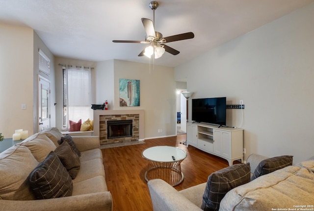 living room with ceiling fan, a fireplace, and hardwood / wood-style floors