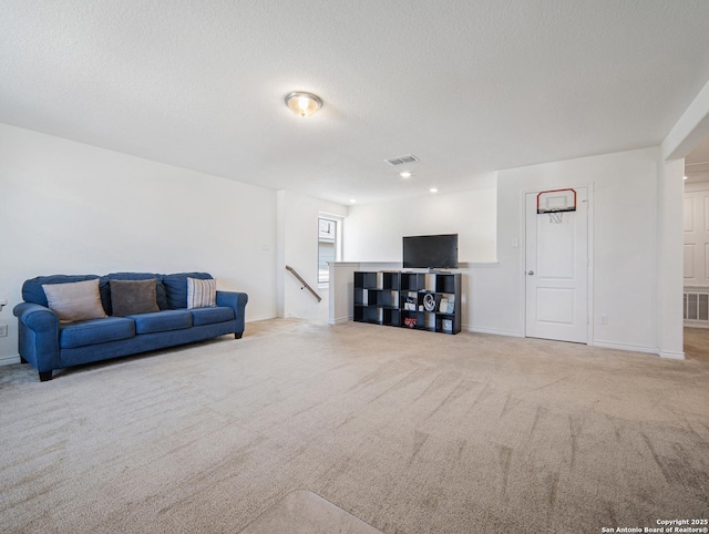 living room with light colored carpet and a textured ceiling