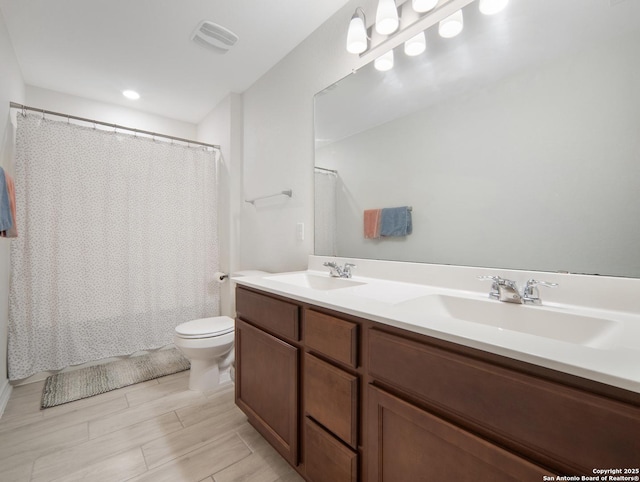 bathroom featuring vanity, a shower with curtain, and toilet