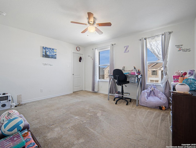 carpeted home office featuring a wealth of natural light and ceiling fan