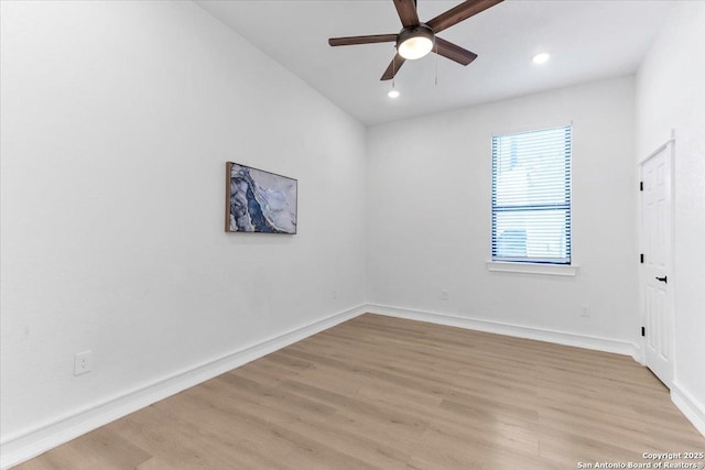 spare room featuring light hardwood / wood-style floors and ceiling fan