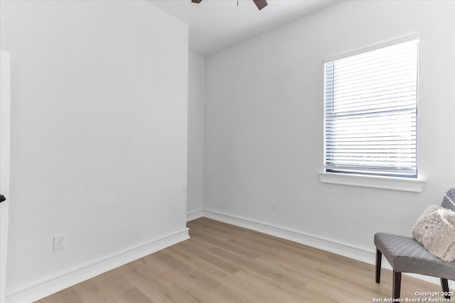 living area with ceiling fan and light hardwood / wood-style flooring