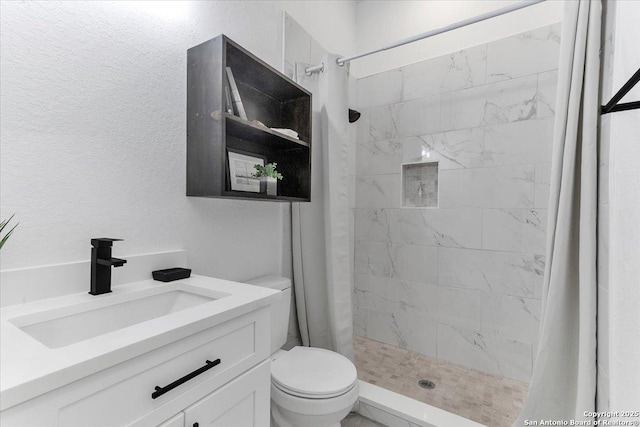 bathroom featuring vanity, toilet, and curtained shower