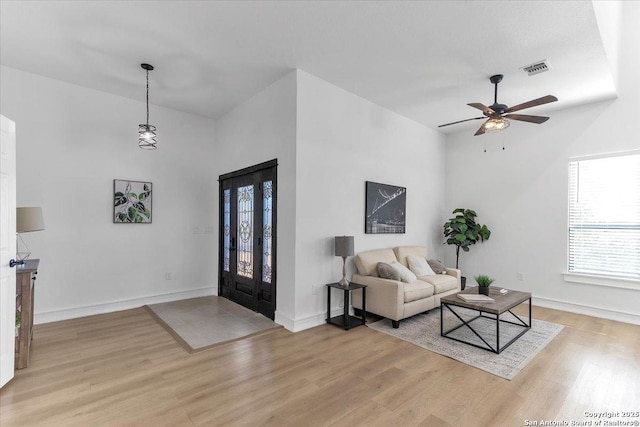 living room featuring ceiling fan and light hardwood / wood-style flooring