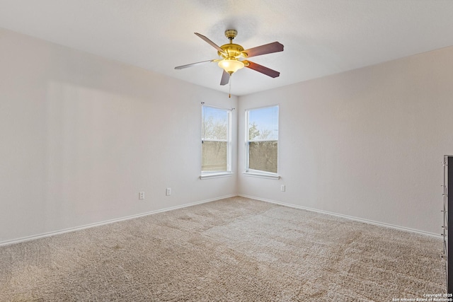 unfurnished room featuring ceiling fan and carpet