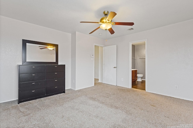 unfurnished bedroom with ensuite bathroom, ceiling fan, and carpet flooring