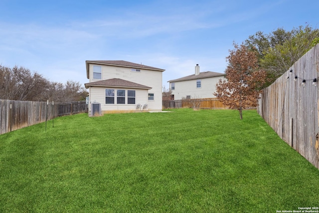 back of property featuring central AC and a lawn