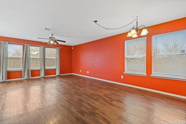 unfurnished room featuring wood-type flooring and ceiling fan with notable chandelier