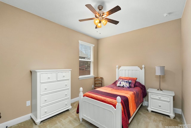 bedroom featuring light colored carpet and ceiling fan