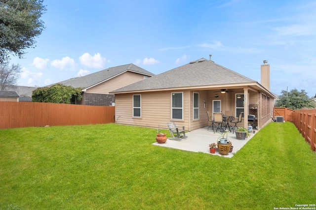 rear view of property featuring a patio, cooling unit, ceiling fan, and a lawn