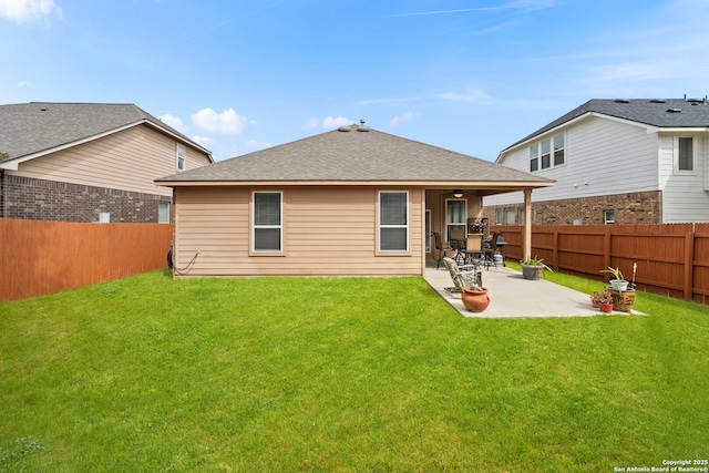 back of property with a yard and a patio area