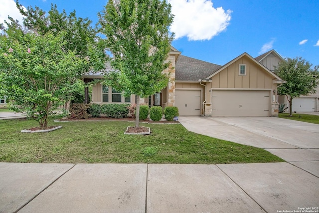 view of front of property featuring a garage and a front lawn