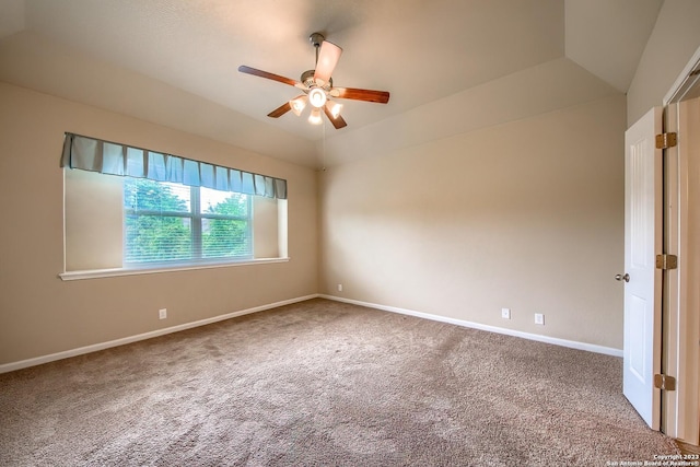 spare room with vaulted ceiling, ceiling fan, and carpet floors