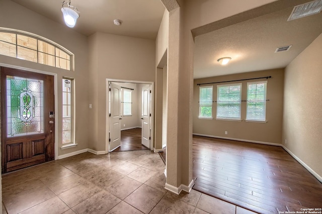 foyer entrance with tile patterned flooring and a wealth of natural light