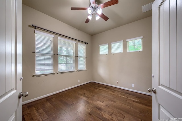 empty room with dark wood-type flooring and ceiling fan