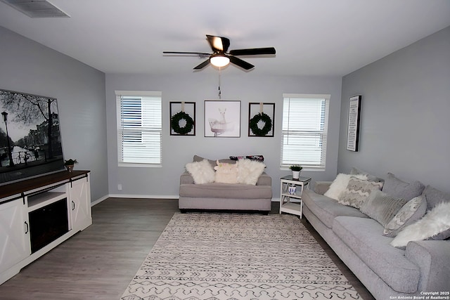 living room featuring hardwood / wood-style floors and ceiling fan