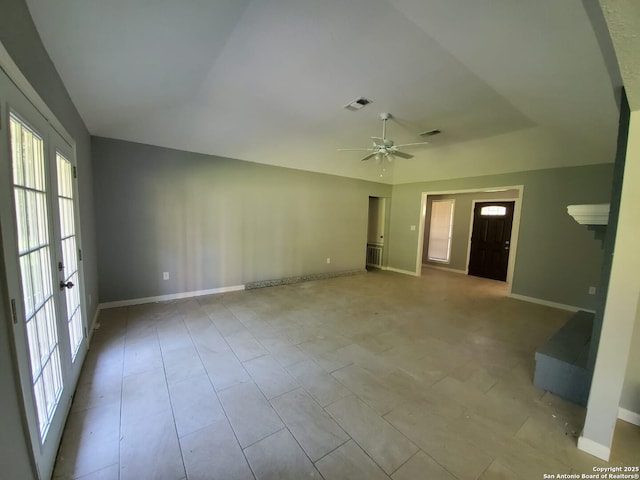 empty room with ceiling fan and lofted ceiling