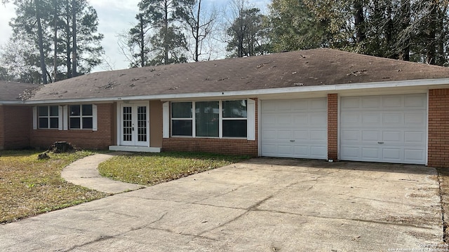 view of front of property with french doors, a garage, and a front yard