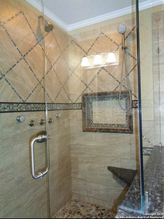 bathroom featuring crown molding and walk in shower