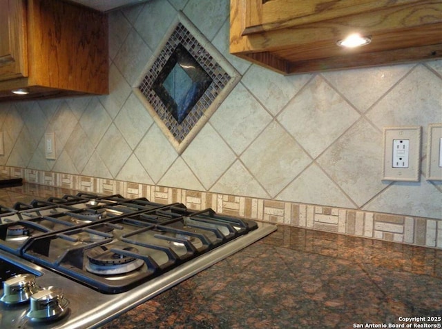 kitchen featuring backsplash and cooktop