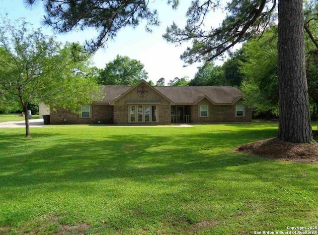 ranch-style home featuring a front yard