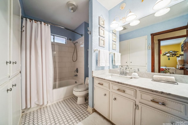 full bathroom with shower / bath combo, vanity, and toilet