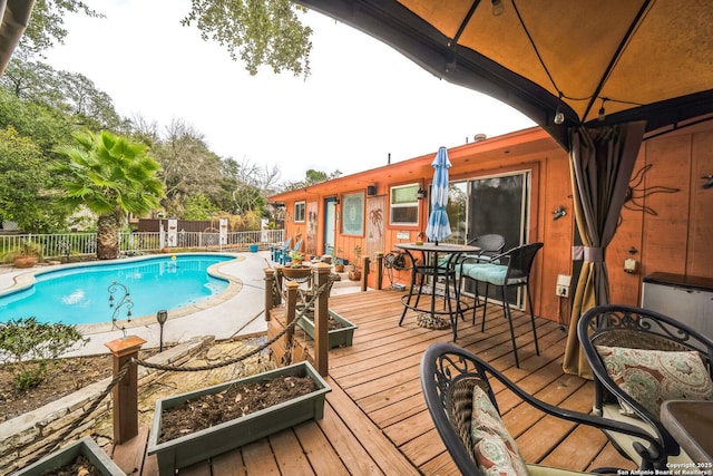 view of swimming pool with a deck