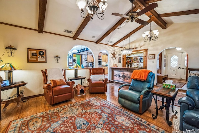 living room featuring wood-type flooring, high vaulted ceiling, ceiling fan with notable chandelier, and beam ceiling