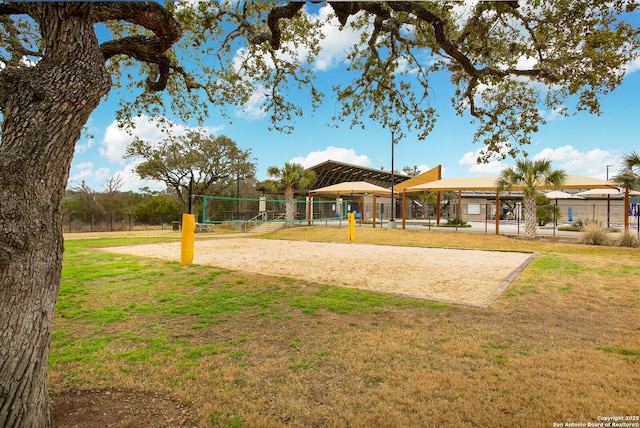 view of community featuring a lawn and volleyball court